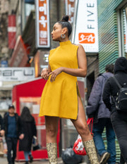 Model wearing jeju dress in crown gold in new york